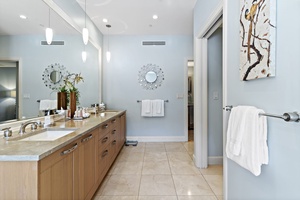 The ensuite bathroom has ample vanity spaces.