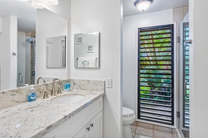Wailea Ekolu 1605 bathroom features a large vanity, modern fixtures, and natural light.
