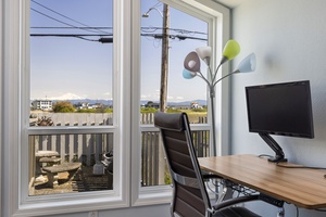 Work remotely with an inspiring view—this dedicated desk space overlooks the serene shoreline.