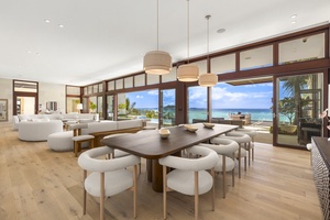 Spacious dining table and living room with ocean views, perfect for shared meals and conversations.