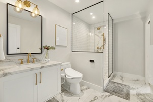 Guest ensuite with single vanity and walk-in shower for comfort and convenience.