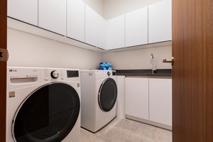 New high-capacity washer and dryer set in a spacious laundry room, perfectly positioned by Bedrooms 2 and the Primary Bedroom for easy access.