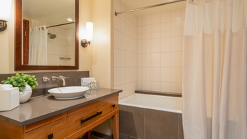 The second guest bathroom features a shower and tub combo.