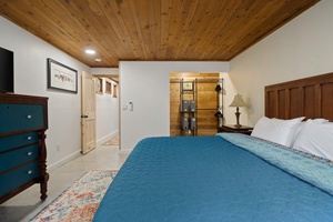 Spacious layout and warm wood ceilings give this king bedroom a peaceful, retreat-like feel.