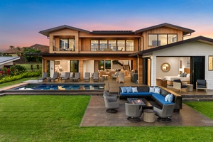 Modern luxury home featuring premium outdoor entertaining spaces with swimming pool, hot tub, elegant fire pit seating, and contemporary architecture at twilight.