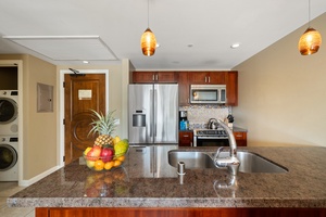 This fully stocked kitchen at Honua Kai Konea 230 features granite countertops and stainless appliances for seamless meal prep.