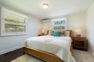 Cozy guest bedroom featuring a plush bed, natural light, and tranquil tones for restful nights.