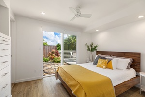 Guest house bedroom with fresh linens, direct lanai access, and peaceful garden views for a relaxing island retreat.