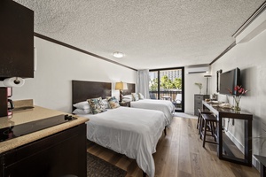 Bright and airy studio with two queen beds and lanai access, offering flexibility for couples or families.