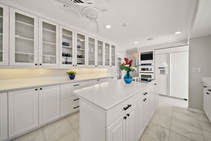 Sleek kitchen area with a fresh white finish, inviting culinary creativity.