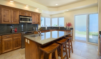 Host and cook with ease in this open kitchen featuring a party-size ice maker, wine cooler, and bar seating.