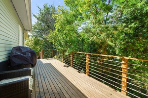 This private deck features a cozy sitting area, creating a quiet retreat to read, relax, or enjoy the fresh air.