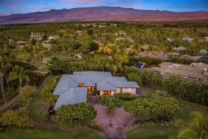 Evening aerial view highlighting the stunning backdrop of the Kohala Mountains at dusk.