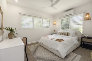 Guest bedroom with natural light and individual AC