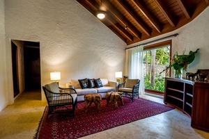 Gather in this cozy sitting area with natural light and garden view.