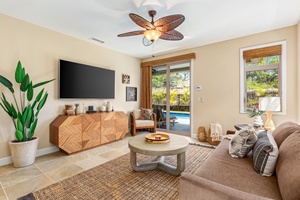 Downstairs living area with sliding glass doors to lower lanai and pool deck.