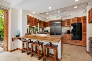 Your fully equipped kitchen features granite counters, stainless appliances, and a breakfast bar perfect for morning coffee.