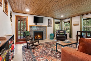 Gather around the electric fireplace for cozy evenings in, enhanced by vintage rugs and smart TV entertainment.