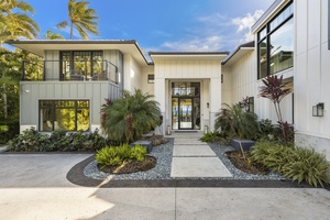 Welcoming entry framed by tropical landscaping, setting the stage for your stay.