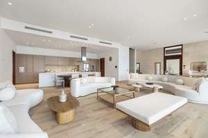 Open-concept layout seamlessly connects the dining table, living room, and kitchen, ideal for group entertainment.
