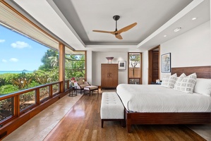 Primary bedroom with sitting area and ensuite bath.