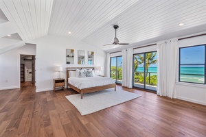 Retreat in the primary suite's king bed, cooled by a fandelier and modern split AC.