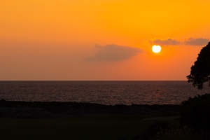 Breathtaking sunset over the ocean creates a breathtaking golden backdrop for this coastal property location.