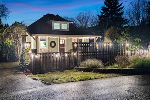 Front view of the house decorated with sparkling lights, bringing holiday cheer to the neighborhood.