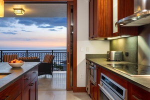 The fully-equipped kitchen has top tier appliances and direct access to the lanai with views.