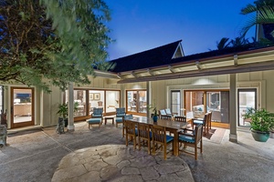 Main house outdoor lanai with spacious dining setup, ideal for al fresco gatherings under the stars.