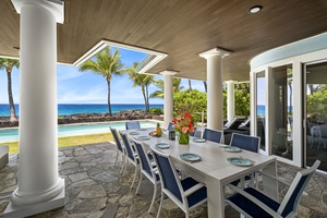 Enjoy outdoor dining under the covered lanai with stunning ocean views.