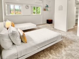 Cozy bedroom one with soft tones, attached to the bedroom two.