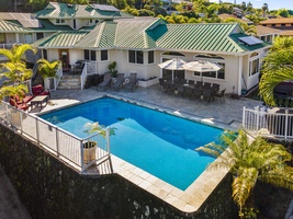 Elevated pool deck with ocean views and shaded outdoor seating.