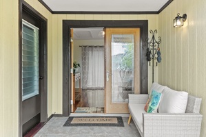 A tropical entryway greets you with island charm and a cozy place to kick off your slippers.
