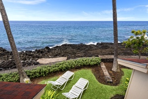 Wake up to this view—lush greenery, lava rock, and the endless blue sea.