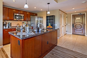 The kitchen at Honua Kai Konea 232 boasts a modern design and spacious, user-friendly layout.