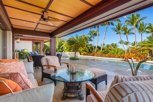 Outdoor dining with pool views and lush surroundings.