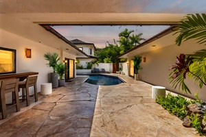 Step into your private courtyard oasis, where the pool glows in the golden dusk light—ideal for a refreshing dip before an al fresco dinner.