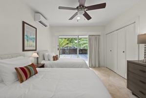 Another guest room with twin beds and direct outdoor access for fresh breezes.