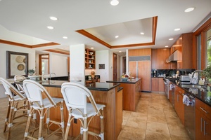 Modern gourmet kitchen with bar seating and center island.