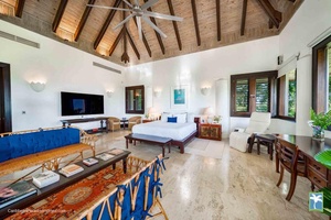 Relax in this spacious primary bedroom featuring elegant decor and king size bed.