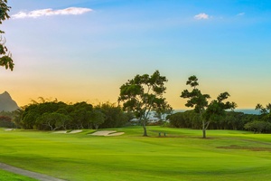 Golf course at golden hour, just steps from the home, offering stunning scenery and leisure.