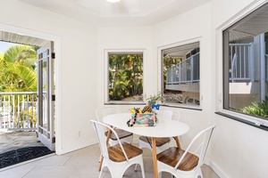 Enjoy your morning coffee at this bright dining spot with tropical garden views through large windows.