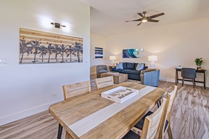 Kapalua Ridge 1421’s open dining and living area features modern decor and cozy seating.