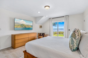 Sun-kissed suite with calm colors, ocean glimpses, and cozy corner reading vibes.