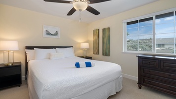 Peaceful and airy, the primary bedroom offers serene views and access to a nearby ensuite, ideal for guests seeking privacy and comfort.