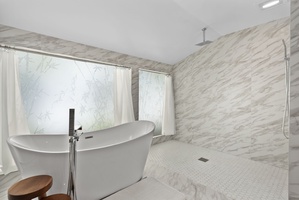 Unwind in the deep soaking tub after a day at the beach—set against gleaming marble at Honolulu Lagoonfront Villa.
