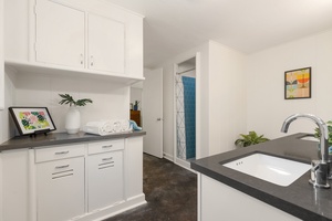 The thoughtfully designed primary bathroom offers ample storage, a large vanity, and a clean, contemporary layout that makes getting ready effortless.