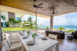 Dine al fresco in this elegant outdoor dining area, complete with ocean views.