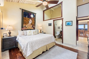 King guest suite with ceiling fan, plush linens, and charming Hawaiian touches—cozy yet elegant.